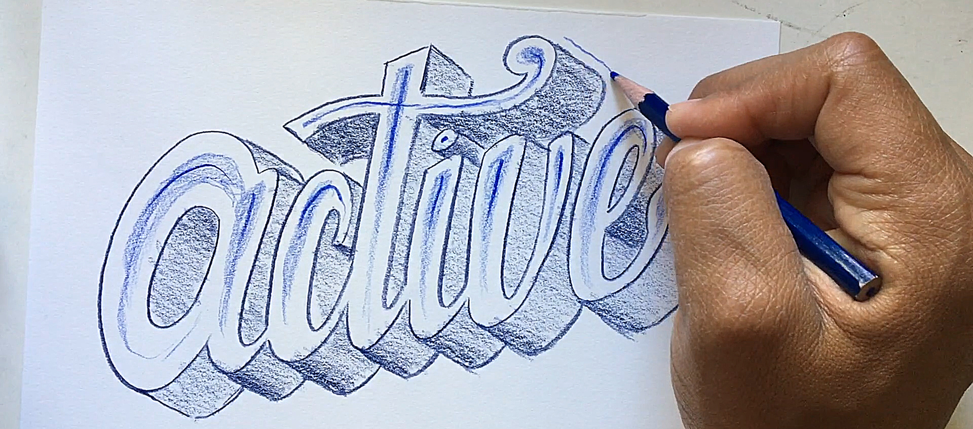 The hand of artist and author Robert Liu-Trujillo drawing a decorative treatment of the word "active"