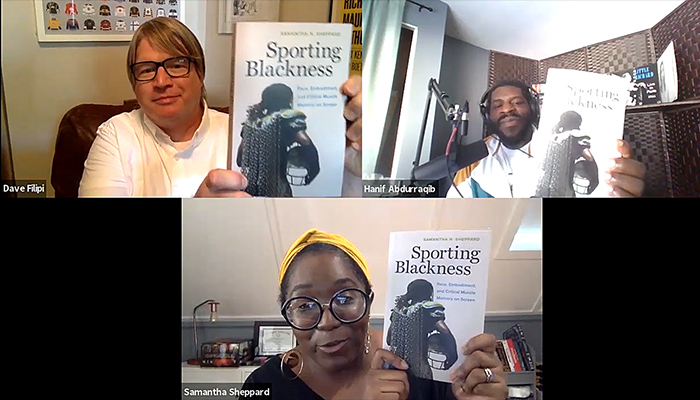 Three people in a Zoom call each hold up the book Sporting Blackness.
